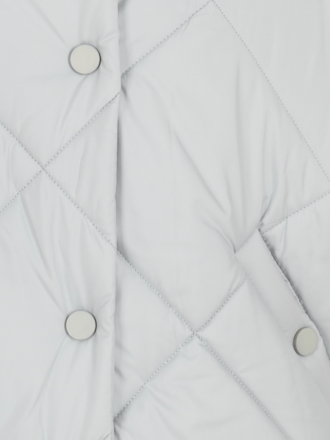 Close-up detail of the light blue puffer jacket, showing the buttons and diamond stitching pattern.