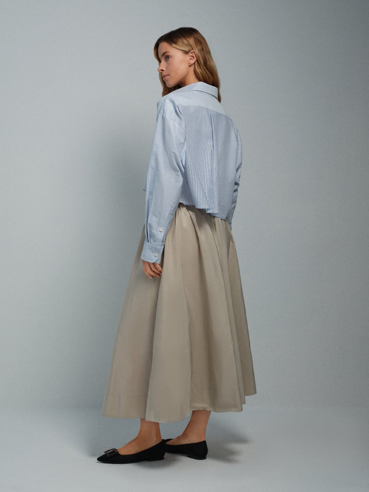 Angled back view of women’s taupe taffeta midi skirt, full A-line silhouette.