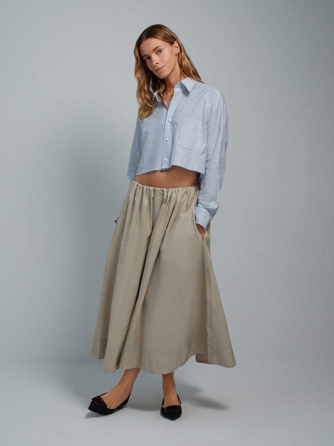 Women’s beige taffeta midi skirt, full A-line silhouette with pockets.