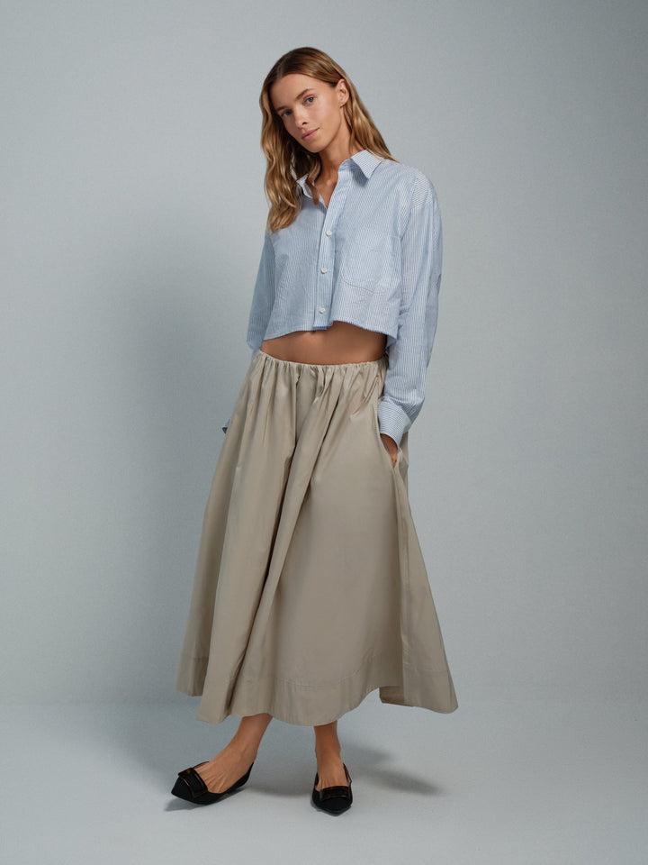 Women’s beige taffeta midi skirt, full A-line silhouette with pockets.