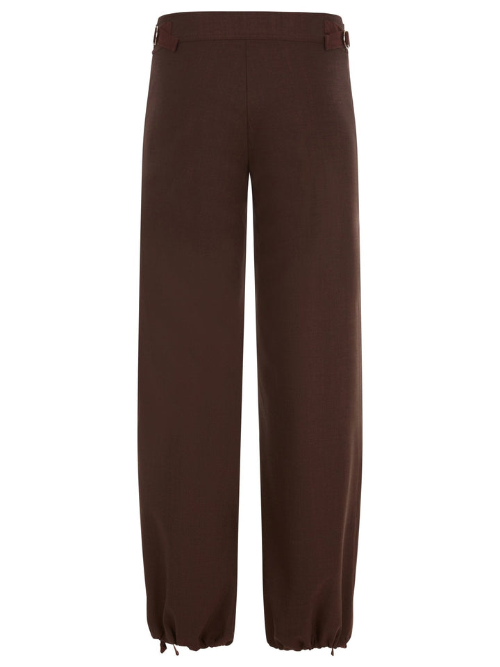 Back view of brown wide-leg pants with ankle drawstrings and a button closure, displayed on a white background.