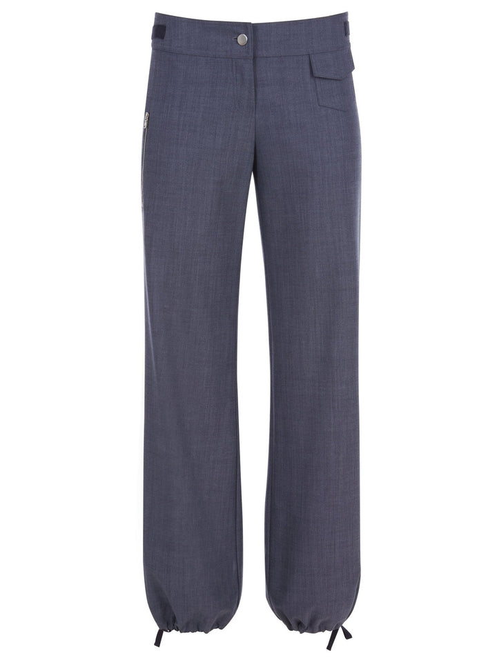 Front view of blue relaxed-fit pants with a button closure, drawstring-adjustable ankle cuffs, and a utility pocket detail on the upper side displayed on a white background.