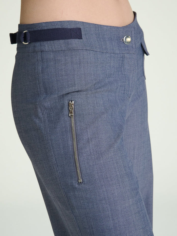 model wearing fitted heather blue trousers with nickel trims