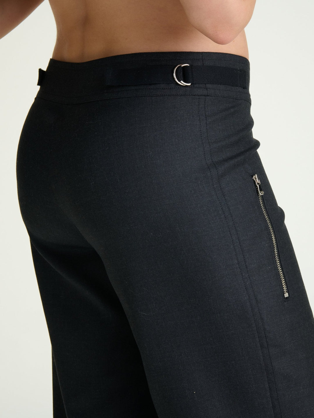 model wearing fitted heather charcoal trousers with nickel D rings and nickel side zipper