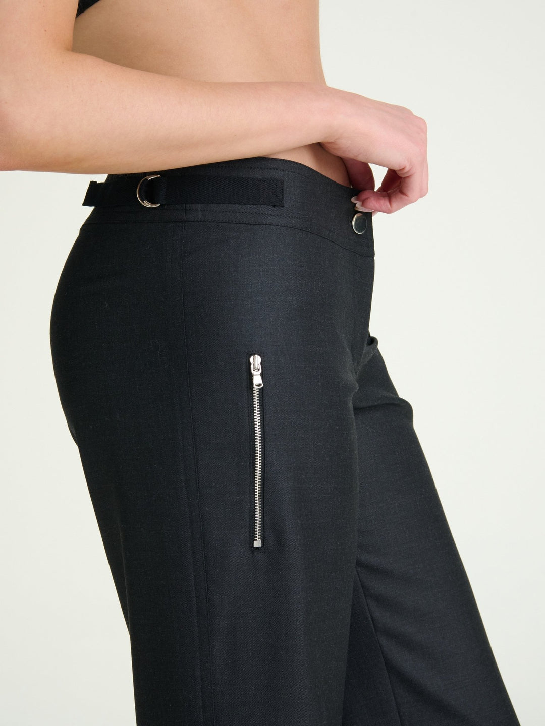 model wearing fitted charcoal heather trousers with a heather ribbon and D rings on the side