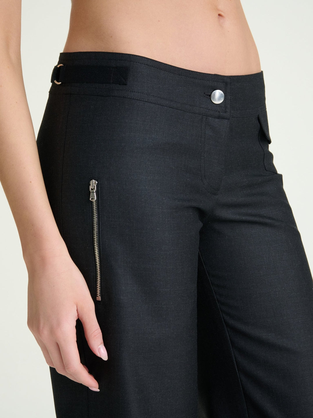 zoomed in photo of model wearing heather charcoal wool pants with a nickel button and nickel side zipper