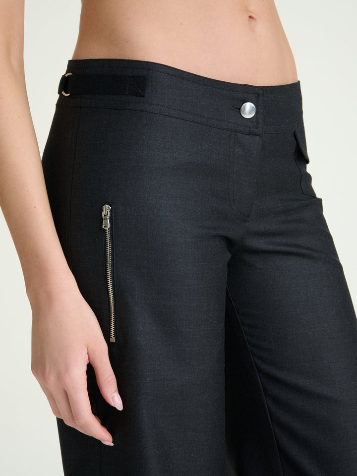 zoomed in photo of model wearing heather charcoal wool pants with a nickel button and nickel side zipper