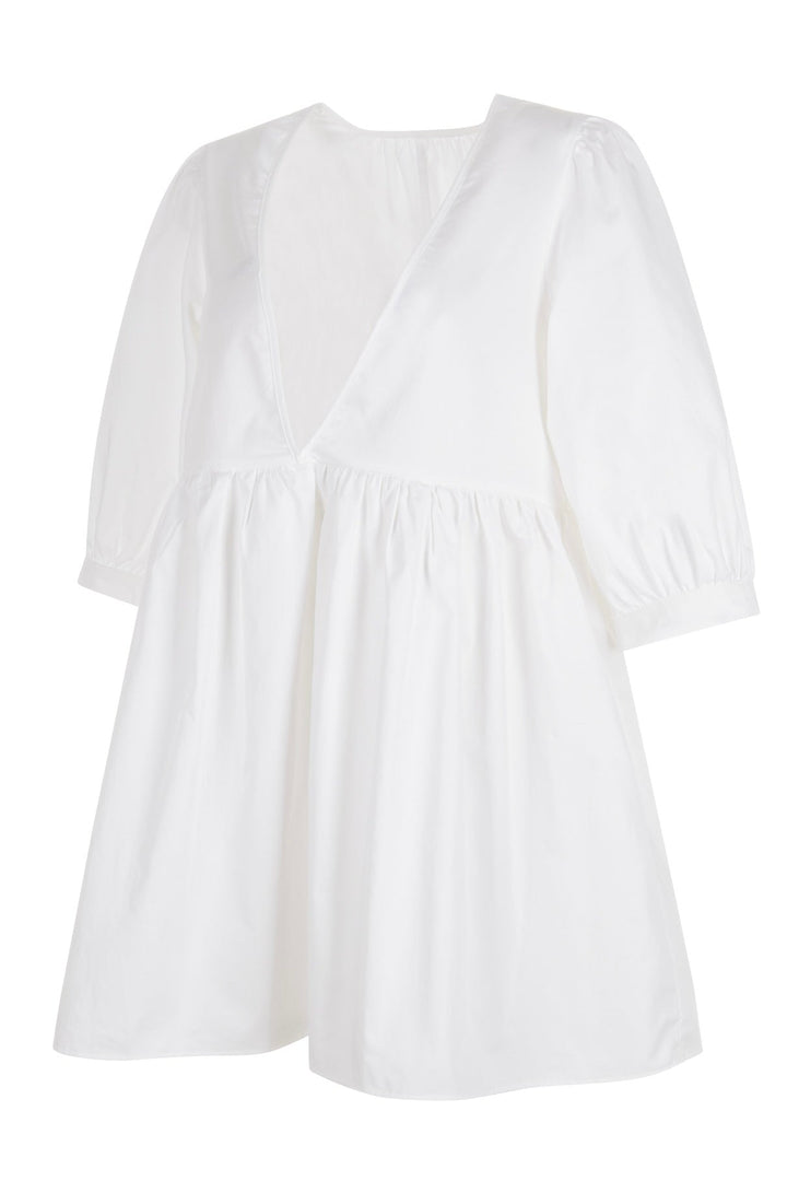 Side view of white mini dress with a deep V-neckline and three-quarter length puff sleeves displayed on a white background.