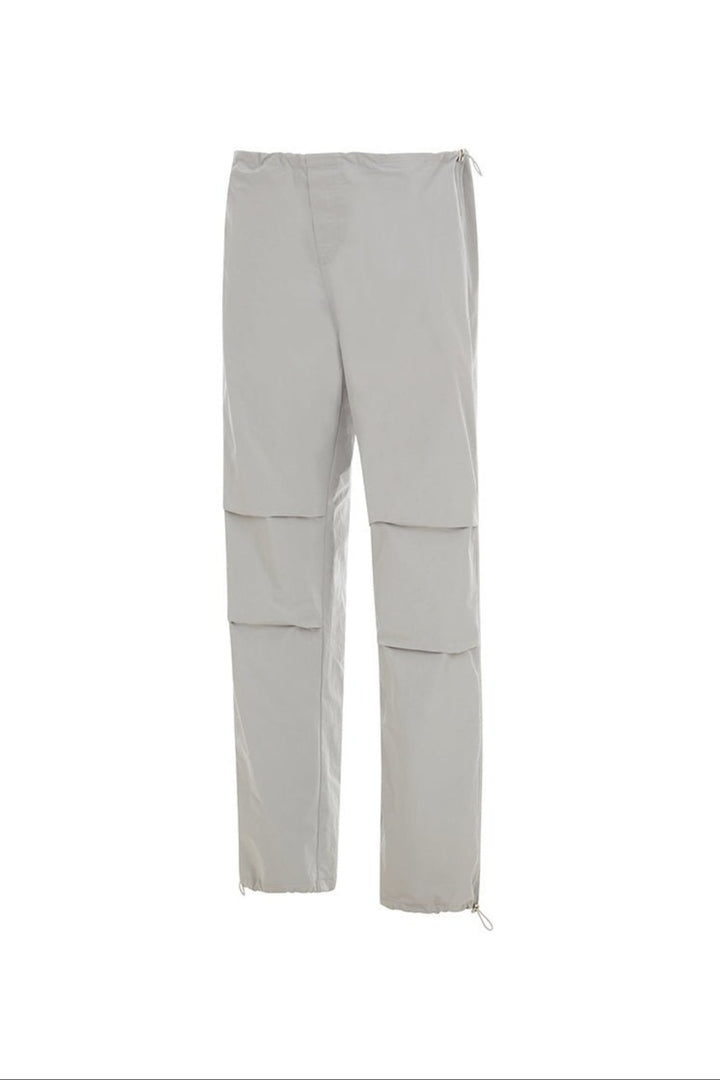 Side view of light grey pants on a white background.