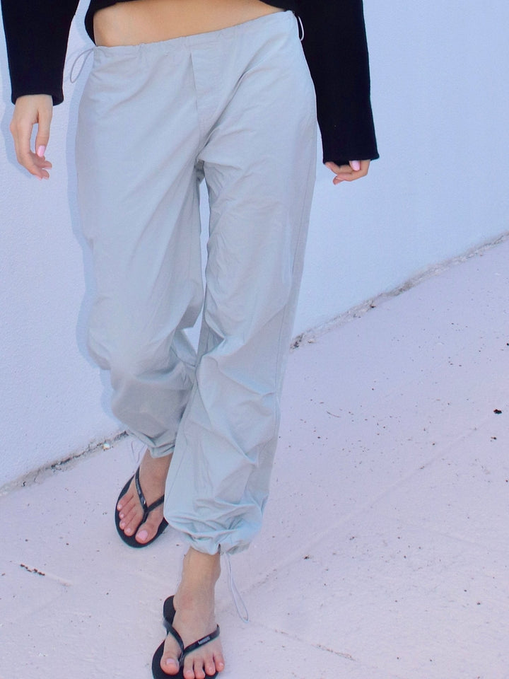 Model wearing  light grey drawstring pants with a relaxed fit.