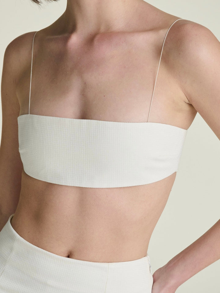 off-white bandeau with thin elastic straps and a ripstop texture