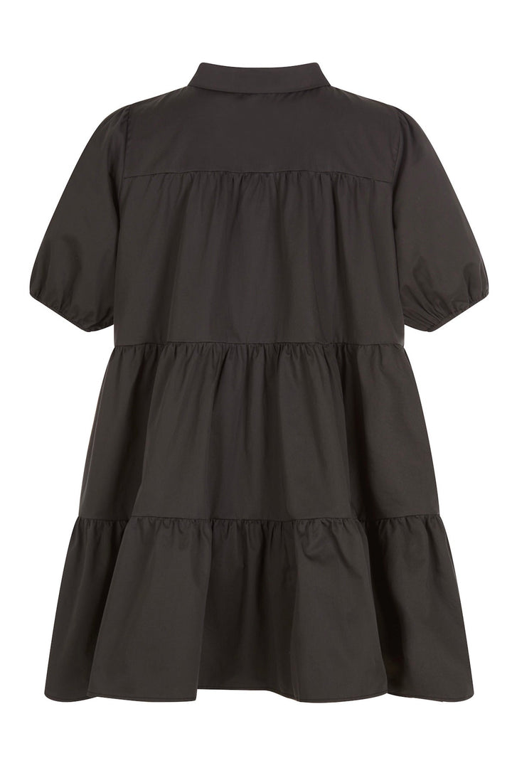 Back view of black short-sleeve dress with buttons down the front, a collar, and tiered ruffles, shown on a white background.