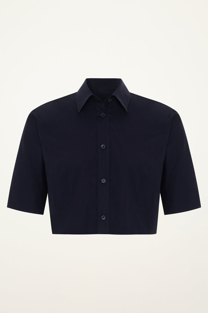 Navy blue short-sleeve button-down cropped shirt on a grey background
