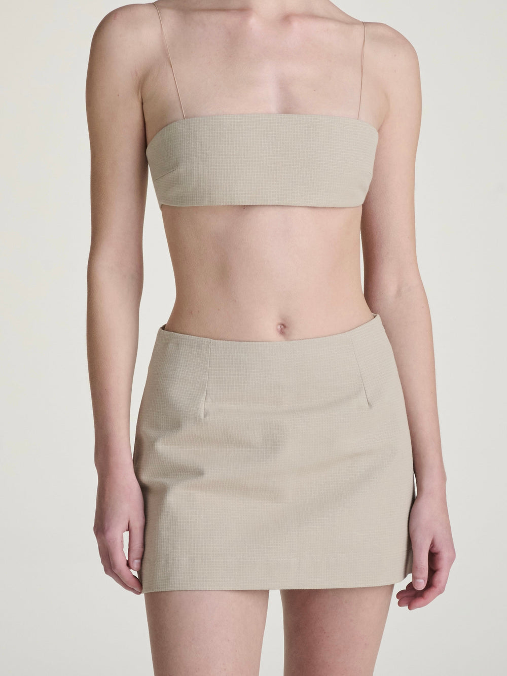 khaki ripstop skort and bralette set on a girl against a grey background