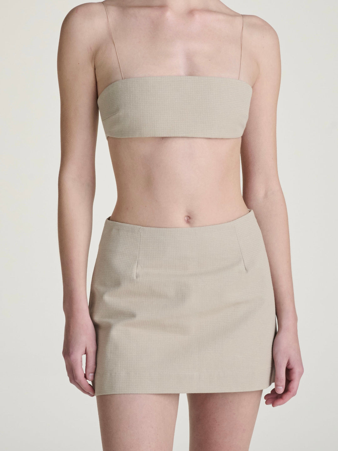 khaki ripstop skort and bralette set on a girl against a grey background