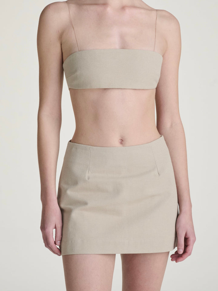 khaki ripstop skort and bralette set on a girl against a grey background