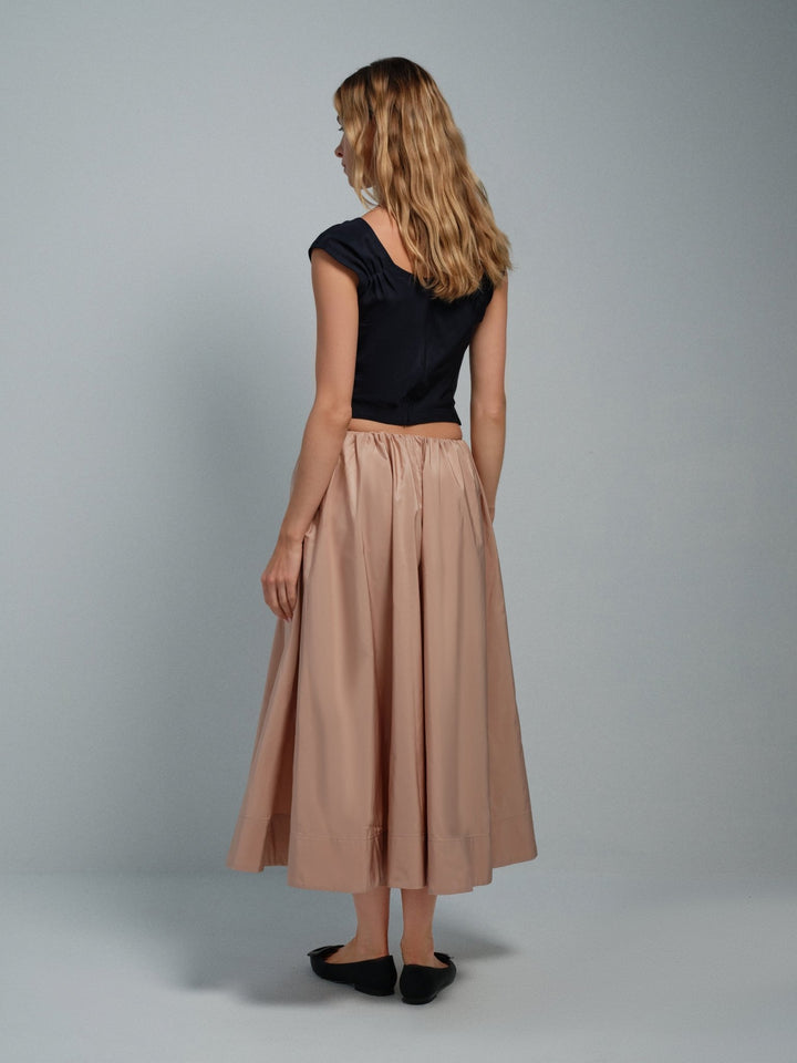 Back angled view of women’s pink taffeta midi skirt, full A-line silhouette.