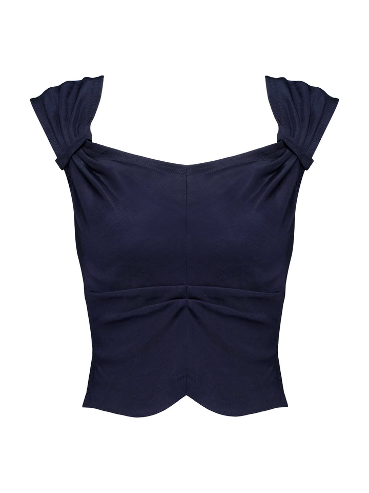 Navy blue top with ruched details on a grey background