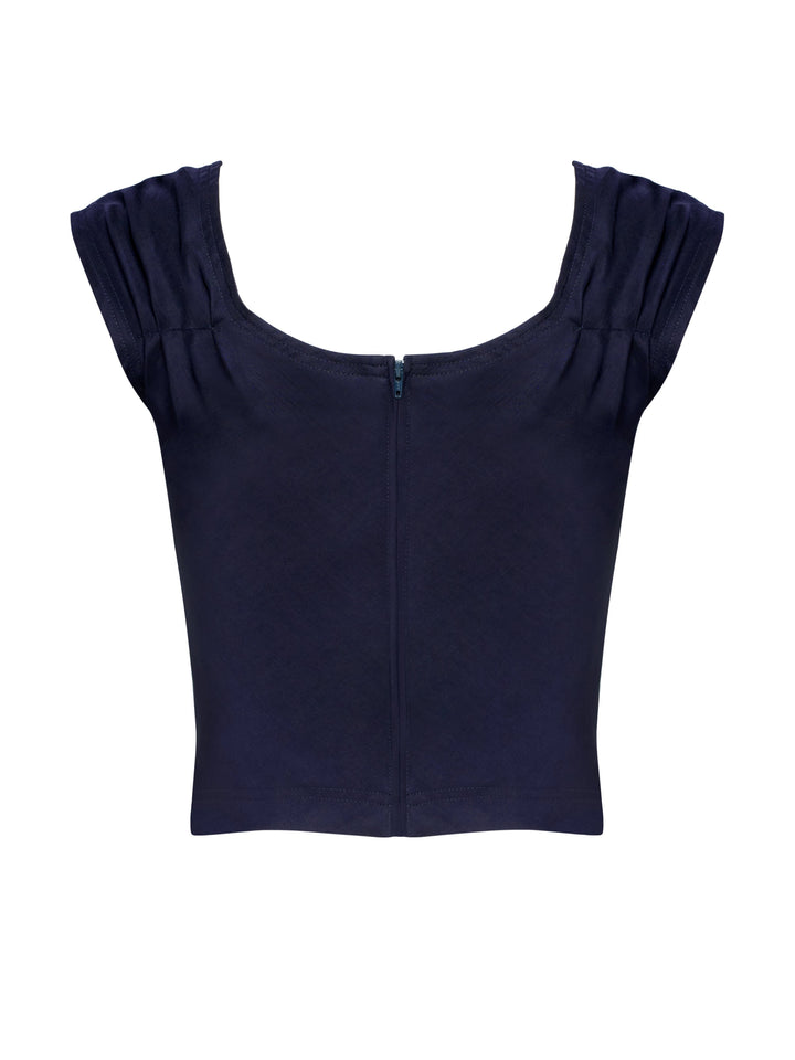 Navy blue top with ruffled shoulders on a grey background