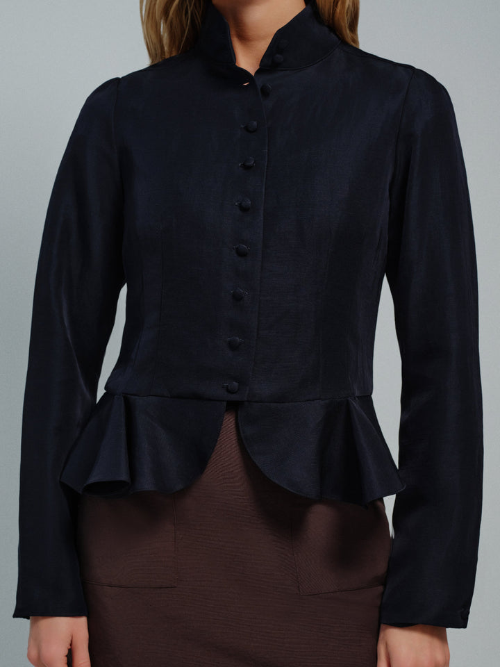 Dark blue peplum blouse with buttons on a gray background