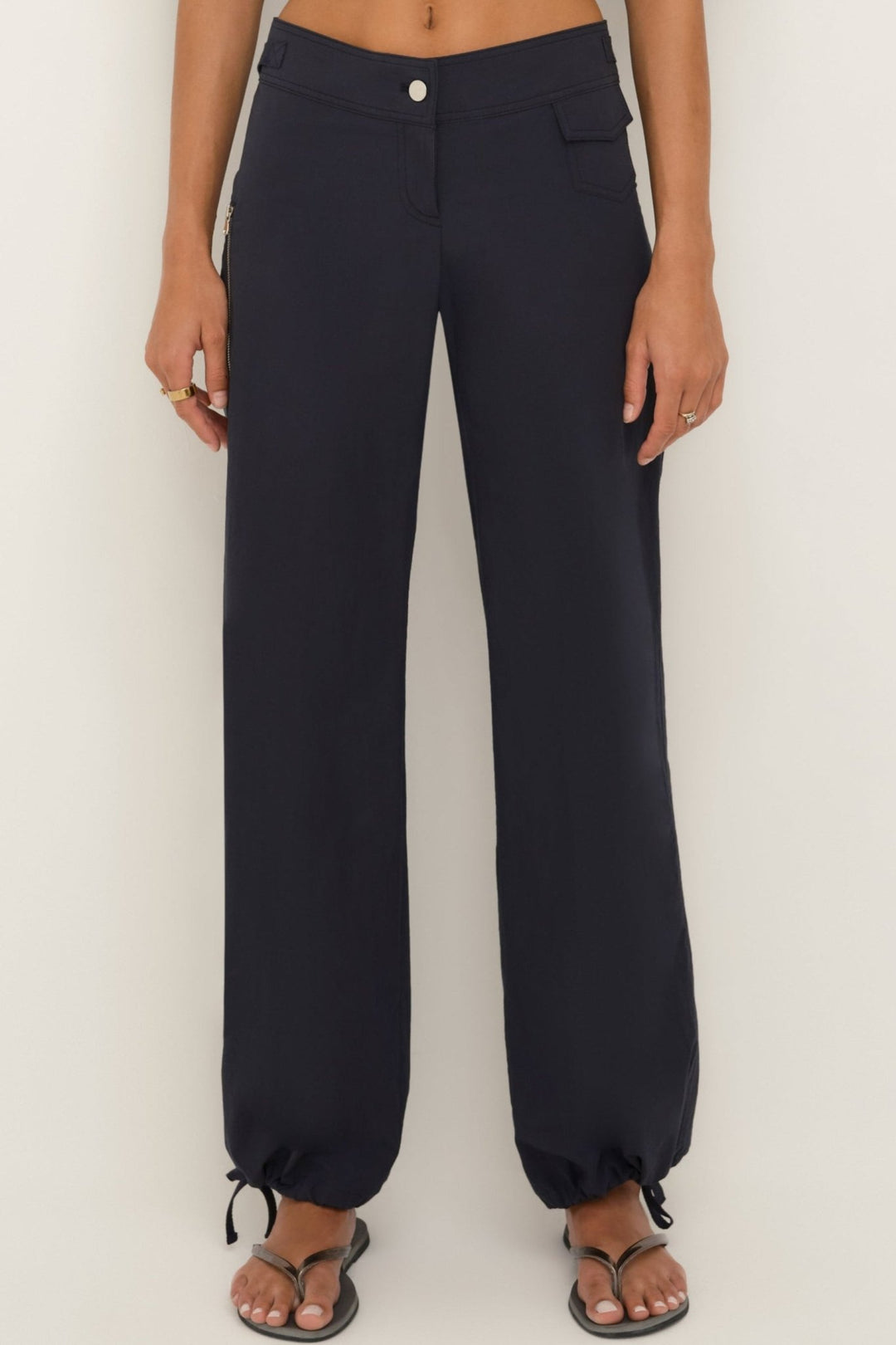 Women’s midnight cotton wide-leg pants with zip pocket and drawstring hems, front view.