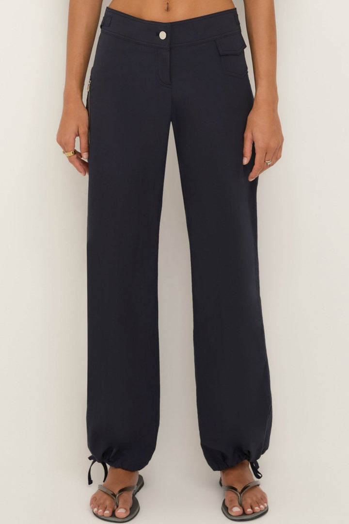 Women’s midnight cotton wide-leg pants with zip pocket and drawstring hems, front view.