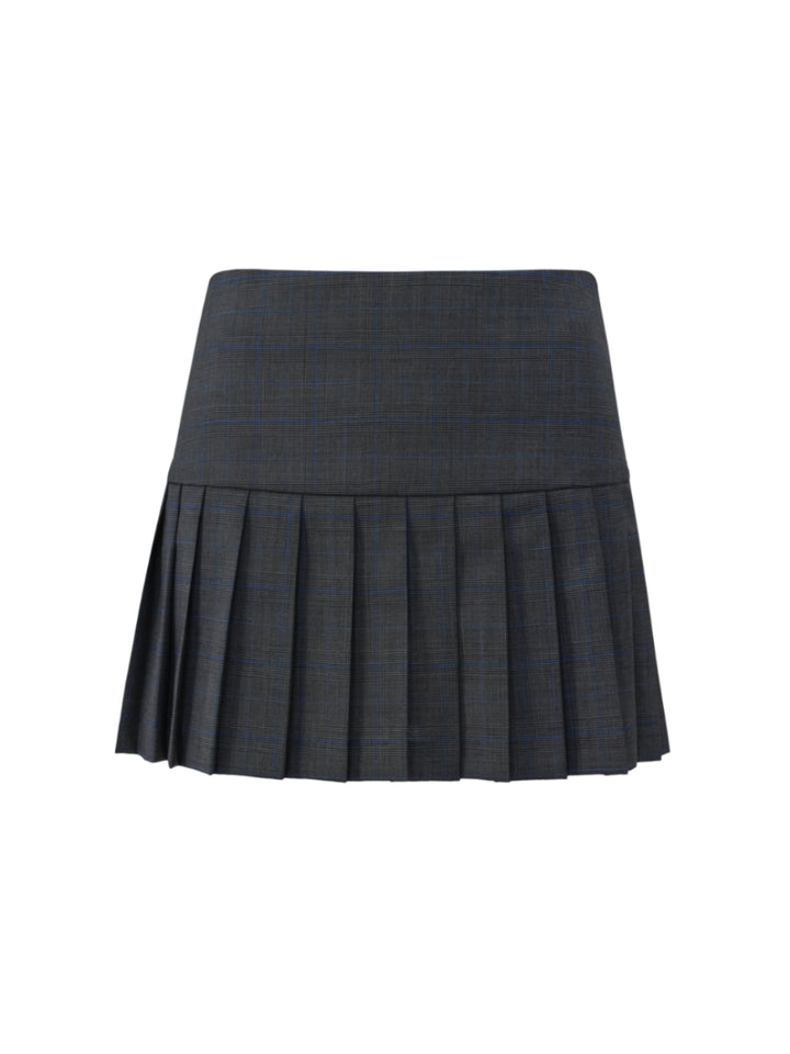 Dark gray navy plaid pleated skirt with a drop waist on a grey background